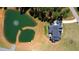 Aerial view of a beautiful home with a private pond and lush green surroundings at 299 Seaforth Landing Dr, Pittsboro, NC 27312