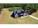 Stunning aerial shot of an estate with pond, expansive lawns and mature landscaping at 299 Seaforth Landing Dr, Pittsboro, NC 27312