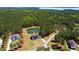 Breathtaking aerial view of an estate home, lush forest, private pond, and pristine landscaping at 299 Seaforth Landing Dr, Pittsboro, NC 27312