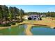 Beautiful aerial view featuring a modern home, large pond, and lush green surroundings at 299 Seaforth Landing Dr, Pittsboro, NC 27312