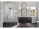 A modern bathroom with black fixtures, a glass enclosed shower, and lots of natural light at 299 Seaforth Landing Dr, Pittsboro, NC 27312