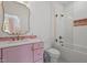 Stylish bathroom features a pink vanity, decorative mirror, and a shower with a glass partition at 299 Seaforth Landing Dr, Pittsboro, NC 27312
