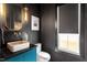 Modern powder room with a marble sink, sleek black walls, and designer lighting at 299 Seaforth Landing Dr, Pittsboro, NC 27312