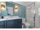 Stylish bathroom showcases patterned wallpaper, a vanity with storage, and a glass-enclosed shower at 299 Seaforth Landing Dr, Pittsboro, NC 27312