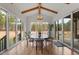 Bright dining room with hardwood floors, modern lighting, and views of the outdoors at 299 Seaforth Landing Dr, Pittsboro, NC 27312