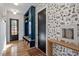 Inviting entryway with hardwood floors, built-in storage, and a stylish wallpaper accent wall at 299 Seaforth Landing Dr, Pittsboro, NC 27312