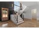A modern staircase with dark wood accents and large windows offering lots of natural light at 299 Seaforth Landing Dr, Pittsboro, NC 27312