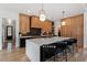 Modern kitchen featuring a large island with seating and custom cabinetry at 299 Seaforth Landing Dr, Pittsboro, NC 27312