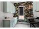 Well-lit laundry room with patterned wallpaper, ample counter space and modern appliances at 299 Seaforth Landing Dr, Pittsboro, NC 27312