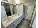 Bathroom with double sink vanity, large mirror, gray floors, and a walk-in shower at 3024 Freewinds Way # 49, Cary, NC 27519