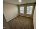 A cozy bedroom features plush carpeting and two windows for natural light at 3024 Freewinds Way # 49, Cary, NC 27519