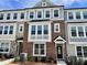 Charming townhome showcasing a brick facade with large windows and a welcoming entrance at 3024 Freewinds Way # 49, Cary, NC 27519