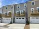 A row of townhomes with garages and balconies, showcasing modern architecture at 3024 Freewinds Way # 49, Cary, NC 27519