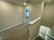Upstairs hallway with carpeted floors and white trim and doors at 3024 Freewinds Way # 49, Cary, NC 27519