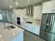 Well-equipped kitchen with stainless steel appliances, gas range, and stylish white cabinetry at 3024 Freewinds Way # 49, Cary, NC 27519