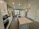Modern kitchen with stainless steel appliances, island with quartz countertop, and pendant lighting at 3024 Freewinds Way # 49, Cary, NC 27519