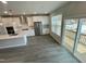 Modern kitchen and sliding glass doors lead to outdoor space, stainless steel appliances, white cabinets at 3024 Freewinds Way # 49, Cary, NC 27519