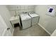 Tile floored laundry room with a utility sink and white washer and dryer at 3024 Freewinds Way # 49, Cary, NC 27519