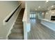 Open-concept living space with a staircase, kitchen island and hardwood style flooring at 3024 Freewinds Way # 49, Cary, NC 27519