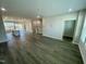 Open floor plan showcasing hardwood floors, kitchen and entryway at 3024 Freewinds Way # 49, Cary, NC 27519