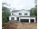 New two-story home with white siding, stone accents, and a two-car garage, situated on a large lot at 362 Barbour Farm Ln, Four Oaks, NC 27524