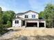 New two-story home under construction with a two-car garage in a wooded neighborhood at 362 Barbour Farm Ln, Four Oaks, NC 27524