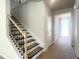 Staircase featuring classic black metal balusters and light wood treads, offering an elegant transition between floors at 362 Barbour Farm Ln, Four Oaks, NC 27524