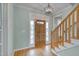 Bright foyer with wood floors, stairs, and a view of the front door at 3808 Hartland Manor Ct, Zebulon, NC 27597