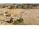Aerial view of house showing pool, driveway, yard, and surrounding fields at 406 Stewart Town Rd, Lillington, NC 27546