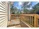 A charming wooden balcony with views of nature and plenty of sunlight creating an outdoor sanctuary at 406 Stewart Town Rd, Lillington, NC 27546