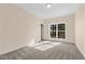 Bedroom featuring neutral-toned carpet, ample natural light, and outdoor views at 406 Stewart Town Rd, Lillington, NC 27546