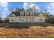 Charming home featuring a welcoming front porch and dormer windows under a blue sky at 406 Stewart Town Rd, Lillington, NC 27546