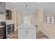 Modern kitchen with a marble countertop island, stainless steel appliances and an open layout at 406 Stewart Town Rd, Lillington, NC 27546