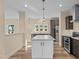Spacious kitchen featuring a large island, stainless steel appliances, and stylish wood flooring at 406 Stewart Town Rd, Lillington, NC 27546
