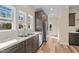 Bright kitchen with stainless steel appliances, granite counters, and window overlooking a natural scene at 406 Stewart Town Rd, Lillington, NC 27546