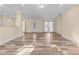 Bright, open living area with wood-look floors, natural light, and views to the kitchen at 406 Stewart Town Rd, Lillington, NC 27546