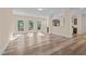 Open living space with wood-look floors, lots of windows, and a seamless flow into the kitchen at 406 Stewart Town Rd, Lillington, NC 27546