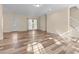 Spacious living room with wood-look floors, neutral walls, and staircase at 406 Stewart Town Rd, Lillington, NC 27546