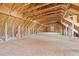 A large unfinished attic with exposed wooden framing, presenting an opportunity for customization and expansion at 406 Stewart Town Rd, Lillington, NC 27546