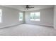 Comfortable bedroom space featuring carpeted floors, ceiling fan, and large windows at 456 Barbour Farm Ln, Four Oaks, NC 27524