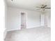 Bright bedroom with plush carpet, ceiling fan, and multiple entryways for adaptable living and easy access at 456 Barbour Farm Ln, Four Oaks, NC 27524
