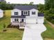 Charming two-story home with a welcoming front porch and a well-manicured lawn and a spacious driveway at 456 Barbour Farm Ln, Four Oaks, NC 27524