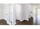 Welcoming foyer with dark wood floors, white trim and staircase, and a charming french door at 456 Barbour Farm Ln, Four Oaks, NC 27524