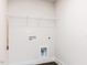 Bright laundry room with vinyl flooring, washer/dryer hookups and wire shelving for optimal storage and convenience at 456 Barbour Farm Ln, Four Oaks, NC 27524