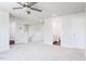 Comfortable loft area with carpet, ceiling fan, and entryways to bedrooms and bathrooms at 456 Barbour Farm Ln, Four Oaks, NC 27524
