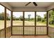Relaxing screened porch with ceiling fan and peaceful backyard view at 456 Barbour Farm Ln, Four Oaks, NC 27524
