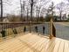 A wooden deck with a metal railing that overlooks the backyard at 4664 Quarter Creek Ln, Liberty, NC 27298