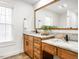 Bathroom with wood cabinets, double vanity sinks, and stylish mirrors at 4664 Quarter Creek Ln, Liberty, NC 27298