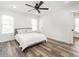 Airy bedroom with wood floors, white walls, and modern ceiling fan with ample natural light at 4664 Quarter Creek Ln, Liberty, NC 27298