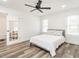 Inviting bedroom with modern ceiling fan, wood floors, and French door access to another room at 4664 Quarter Creek Ln, Liberty, NC 27298